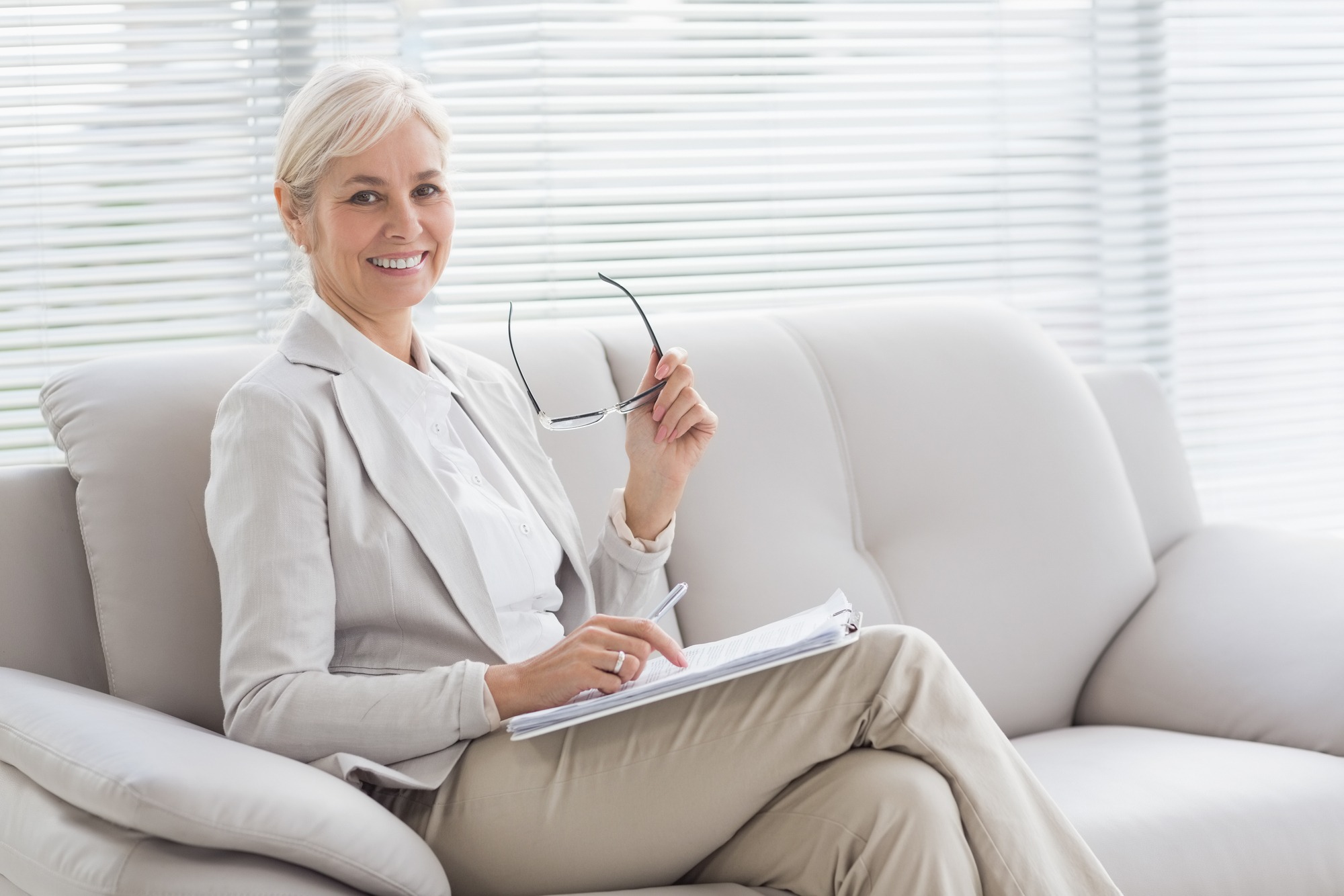 Happy Therapist Sitting On Sofa